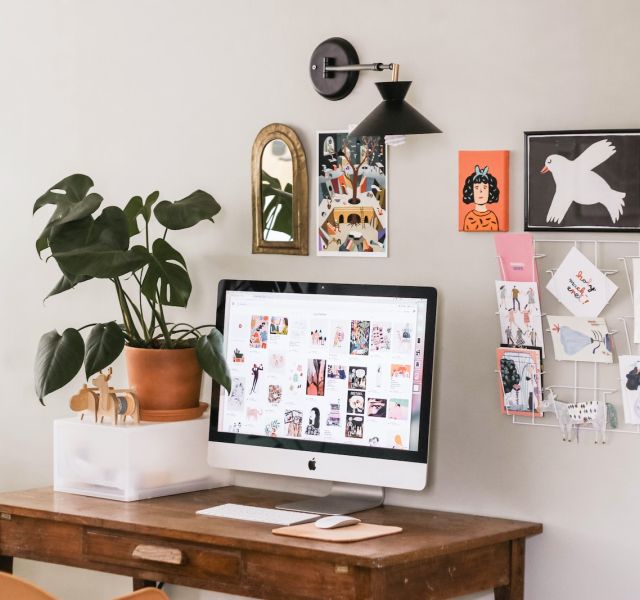 silver iMac on wooden desk