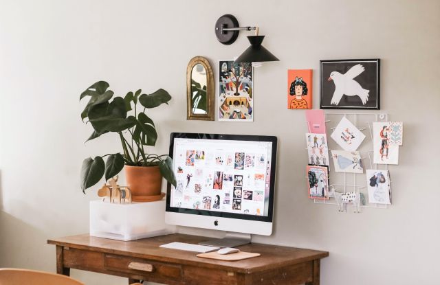 silver iMac on wooden desk