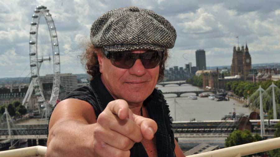 Brian Johnson Standing Beside a Car